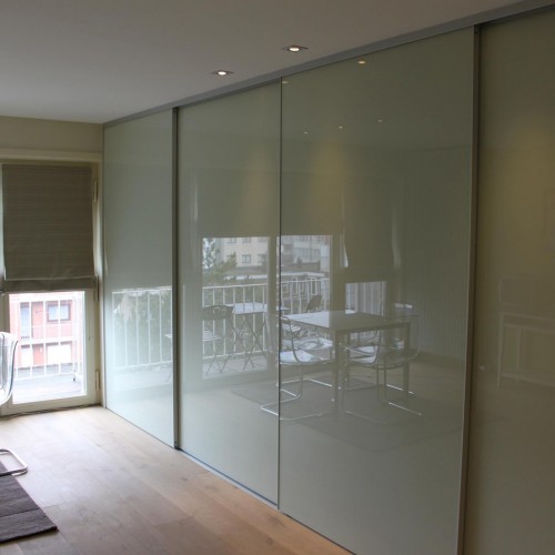 Les propriétaires de cette habitation tenaient à conserver le caractère épuré et ont opté pour une porte coulissante sans poignée. Kast-ID Temse